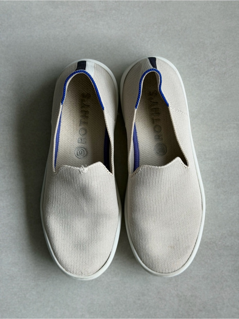 Rothy’s Original Slip-On Canvas Sneakers in Cream with Blue Trim